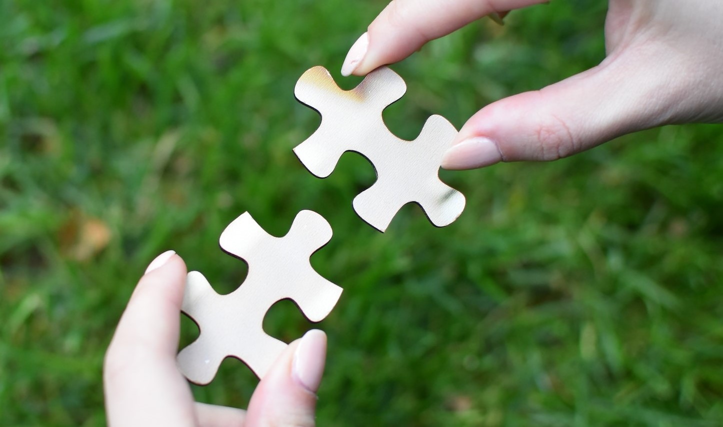 photo of two puzzle pieces fitting together